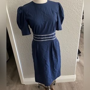vintage navy dress with button down back, and puff sleeves